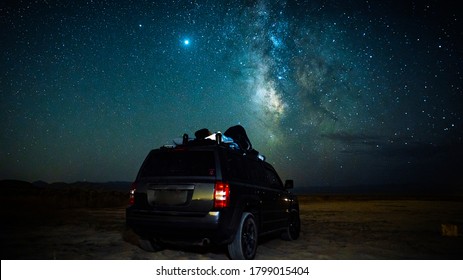 Gorgeous Long Exposure Star-scape Image With The Beautiful Milky-way In The Background And A Car In The Desert For Stargazing.