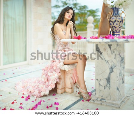 Gorgeous, lovely bride, model preparing to wedding day in front of mirror. Dream wedding with lot of flowers, shiny and ethereal.