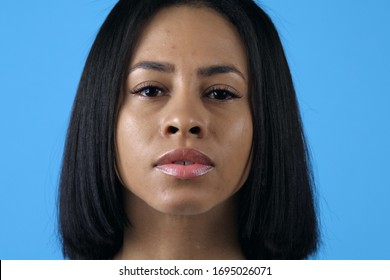 Gorgeous Mid Adult African American Woman With Black Straight Hair Posing Over Blue Background With Serious Deep Looking At Camera   - Shutterstock ID 1695026071