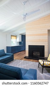 Gorgeous Mid Century Modern Living Room With High White Ceilings, Shiplap Details And A Beautiful Fireplace Surrounded By Modern Furniture Pieces