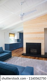 Gorgeous Mid Century Modern Living Room With High White Ceilings, Shiplap Details And A Beautiful Fireplace Surrounded By Modern Furniture Pieces