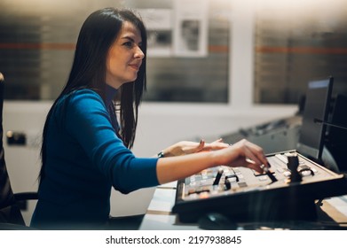 Gorgeous Middle Aged Beautiful Woman Working On A Tv Station As A Producer In A Broadcast Control Room. Show Production Maker. Focus On A Beautiful Woman Face While Working In A Tv Station.