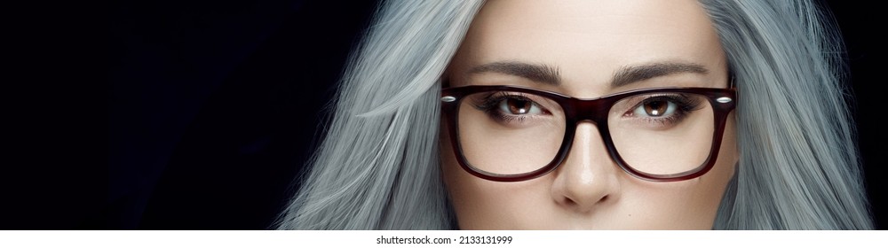 Gorgeous Midle-age Woman With Spectacles Posing In Studio. Optic Eyewear, Clear Vision And Eyecare Concept. Panorama Banner Isolated On Black With Copy Space