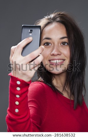 gorgeous mixed-race young woman smiling for her self-portrait on cell phone