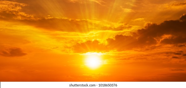Gorgeous panorama scenic of the strong sunrise with silver lining and cloud on the orange sky - Shutterstock ID 1018650376