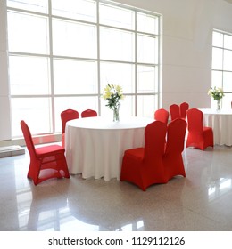 Gorgeous Red Chairs And White Table Setting For Fine Dining.