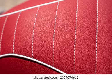 gorgeous red leather motorcycle seat with white stitching - Powered by Shutterstock