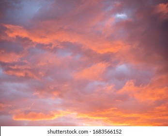 Gorgeous Red And Orange Sunset Clouds Against A Blue Sky.