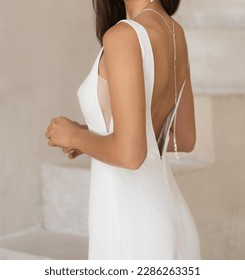 Gorgeous sleeveless and backless wedding dress. Bride in the white wedding dress