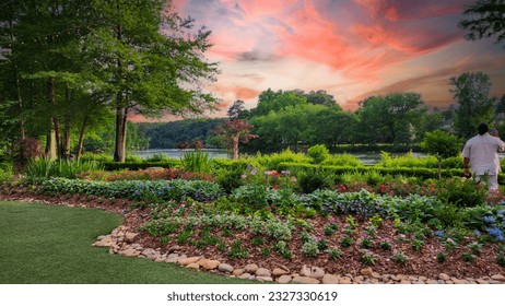A gorgeous spring landscape along the Chattahoochee River with lush green trees, grass and plants and colorful flowers with powerful clouds at sunset at Ray’s on the River in Sandy Springs Georgia - Shutterstock ID 2327330619