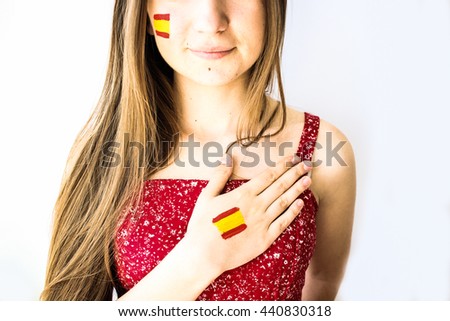 Gorgeous stylish girl football fan with spanish flag singing anthem, hand on heart