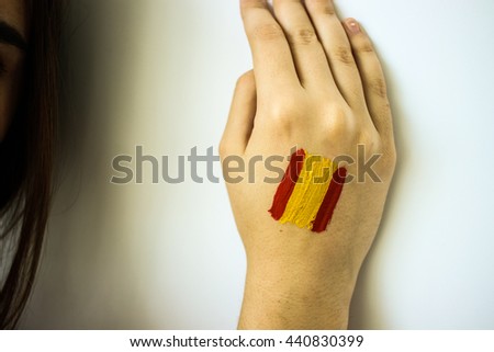 Gorgeous stylish girl football fan with spanish flag on face closeup