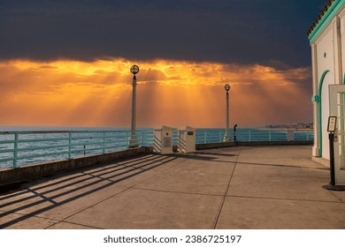 a gorgeous summer landscape along the Manhattan Beach Pier with vast blue ocean water and tall light posts in Manhattan Beach California USA - Powered by Shutterstock