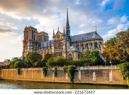 Gorgeous sunset over Notre Dame cathedral with puffy clouds, Paris, France