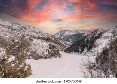 A Gorgeous Sunset Is Seen Over Causey Reservoir In Weber County, Utah Near Ogden, With Frozen Water And Colorful Clouds, No People