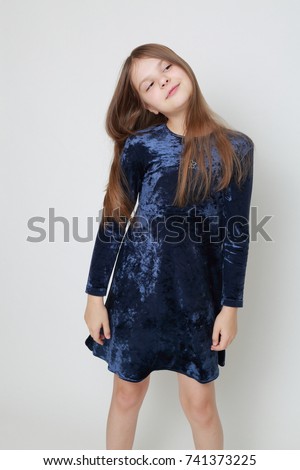 Gorgeous teen girl in a dress posing for a studio portrait