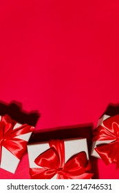 Gorgeous vertical festive Christmas banner or header, holiday presents on red background. Christmas gift boxes on red. Holiday season, New Year. Copy space for text. - Shutterstock ID 2214746531