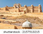 Gorgeous view of the Amer Fort and Palace (Amber Fort) on blue sky background in Jaipur, Rajasthan, India. Rajput military hill architecture. Jaipur is a popular tourist destination of South Asia.