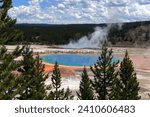 Gorgeous view of the great prismatic spring in Yellowstone National Park. Grey steam rises from the source