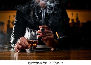 Gorgeous View Of Male Hands Holding A Glass Of Strong Alcoholic Drink And Smoking Cuban Cigar