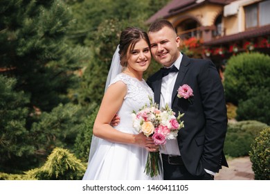 Gorgeous Wedding Couple Walking On The Back Yard Of Couples House. Green Background