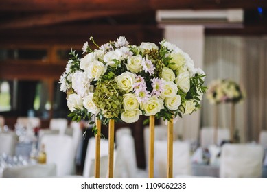 Gorgeous Wedding White Rose And Greenery Centerpiece On A Tall Golden Stand