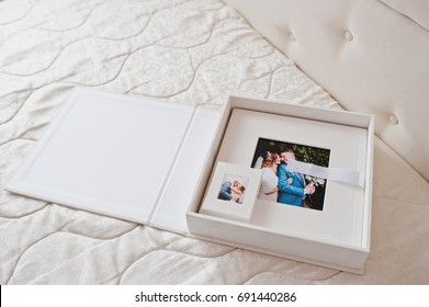 Gorgeous white leather wedding photobooks or photo albums in the box on the white background. - Shutterstock ID 691440286