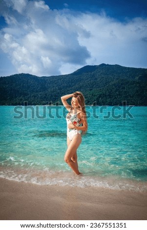 Gorgeous woman in a bikini enjoys the tropical paradise of a sun-kissed beach. Relaxing under palm trees with stunning turquoise water. Concept of a dreamy summer escape.