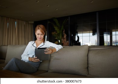 Gorgeous Woman Dressed In Elegant Clothes Watching Video On Digital Tablet While Relaxing In Cozy Restaurant, Young Female Entrepreneur Reading World News In Internet Via Touch Pad During Work Break