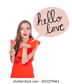gorgeous woman with heart shaped lollipop blowing kiss isolated on white - Shutterstock ID 1012379461