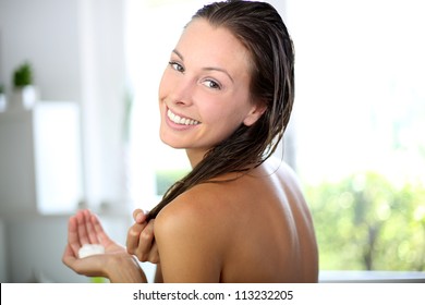 Gorgeous Woman Putting Conditioner In Her Hair