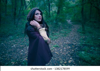 Gorgeous Woman Scared In Autumn Forest In The Evening. Lonely Woman In The Woods. Girl Running Away From Danger Deep In Dark Forest. Scary Autumn Scene