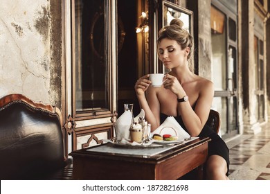 Gorgeous Woman Is Wearing Black Dress In A Vintage Italian Cafe