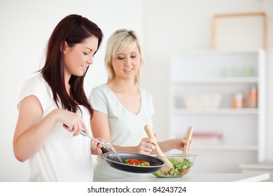 Gorgeous Women Cooking Dinner In A Kitchen