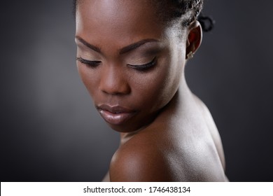 Gorgeous Young African American Woman Looking Down St Copy Space, Over Black Background. Beauty Portrait Of Charming Girl With Clean Skin, Studio Shot