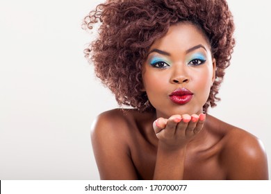 gorgeous young african woman blowing a kiss