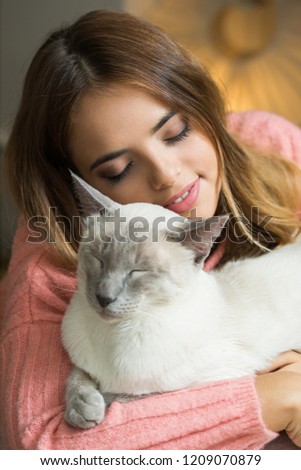 Gorgeous young brunette woman with beautiful cat.