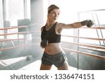 Gorgeous young woman with boxing bandage, standing in the defending position, ready to fight. . Kickboxing and fight sport concept