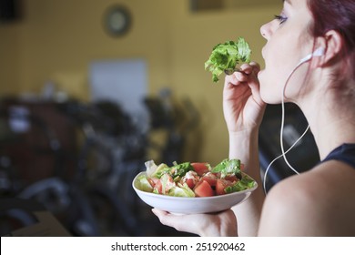 Gorgeous Young Woman At The Gym Eating Salad