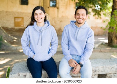 Gorgeous Young Woman And Latin Man With Matching Prints On Their Gray Cotton Sweatshirts