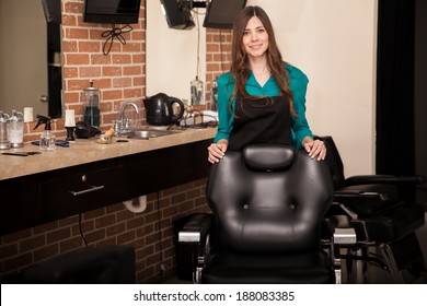 Gorgeous Young Woman Standing Behind A Salon Chair And Greeting Customers To Her Hair Salon