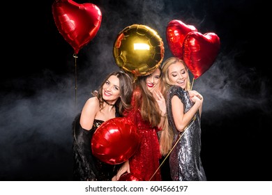 Gorgeous young women in glittering dresses posing with balloons  - Shutterstock ID 604566197