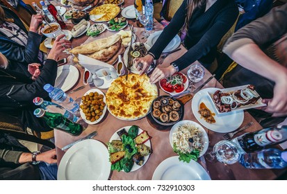 Gori, Georgia - April 23, 2015. Tourists Sitting At The Restaurant Table Full Fo Georgian Traditional Food