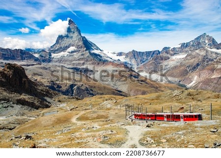 Gornergrat Bahn going up to the Gornergrat train station near Zermatt. Matterhorn peak (also called Cervino or Cervin) is seen in the background.