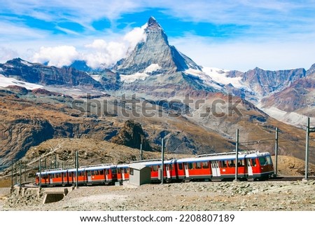 Gornergrat Bahn going up to the Gornergrat train station near Zermatt. Matterhorn peak (also called Cervino or Cervin) is seen in the background.