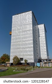 Gosport, Hampshire, England UK. October 2018. Highrise block of flats & apartments covered in plastic sheeting for weather protection whilst work is carried out on the building, Gosport, Hampshire, UK