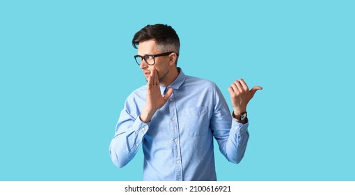 Gossiping man on color background - Shutterstock ID 2100616921