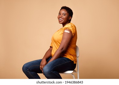 I Got My Covid-19 Vaccine. Happy Black Female Showing Vaccinated Arm After Antiviral Injection For Coronavirus Protection, Posing On Beige Background, Smiling To Camera. Corona Virus Vaccination - Powered by Shutterstock