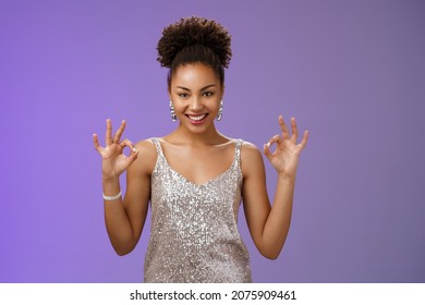Got it perfect deal. Sassy confident attractive creative african-american female in silver glittering evening dress show okay ok gesture smiling devious have excellent idea plan, blue background