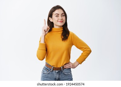 Got A Solution. Proud Smiling Woman Raising Finger In Eureka Sign, Pitching An Idea, Got Excellent Plan, Standing On White Background.